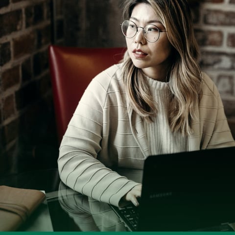 A sales operations lead working through a pricing problem at her laptop